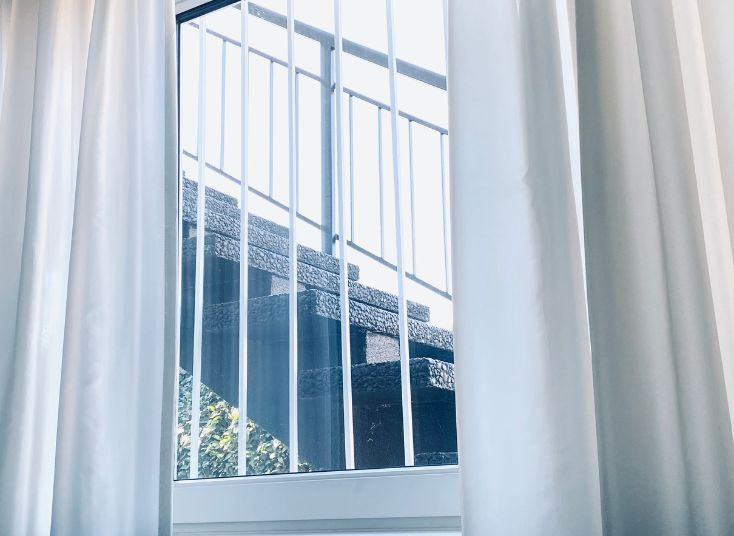 Durable mesh and bar grilles providing secure window and door protection with a sleek, unobtrusive design for enhanced safety and style